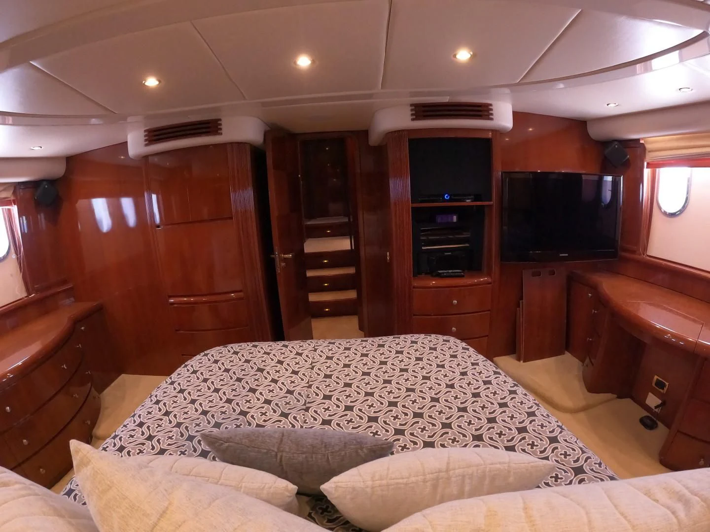 a bedroom with a bed and a tv aboard AZURE Yacht for Sale