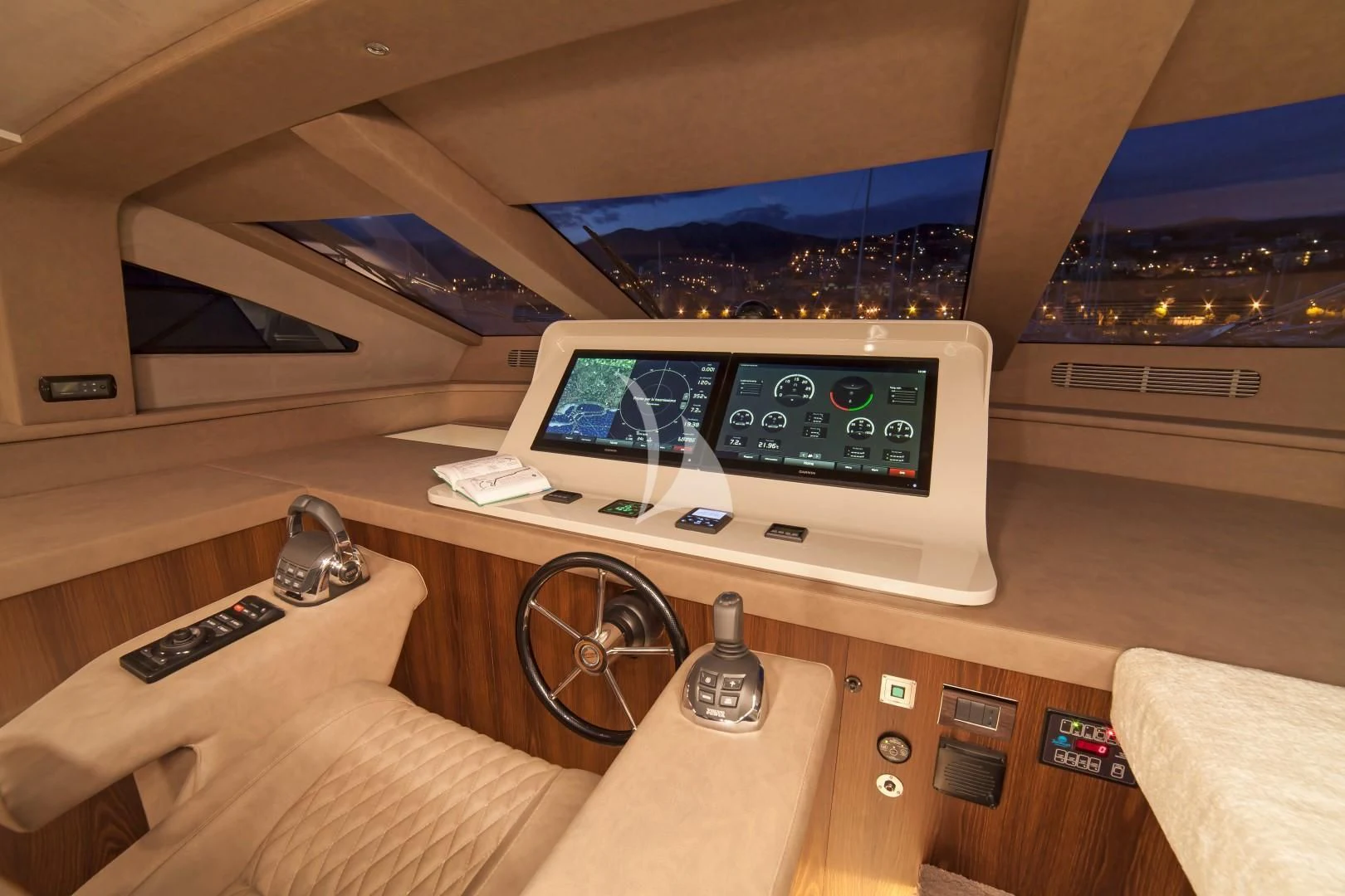 a person's hand holding a remote control in front of a screen aboard SEATALY Yacht for Sale