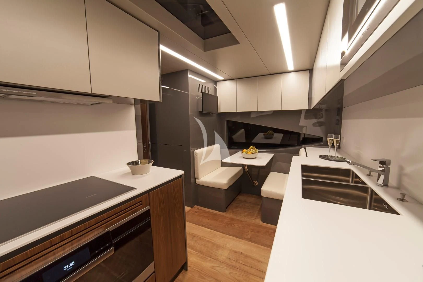 a modern kitchen with white cabinets aboard SEATALY Yacht for Sale