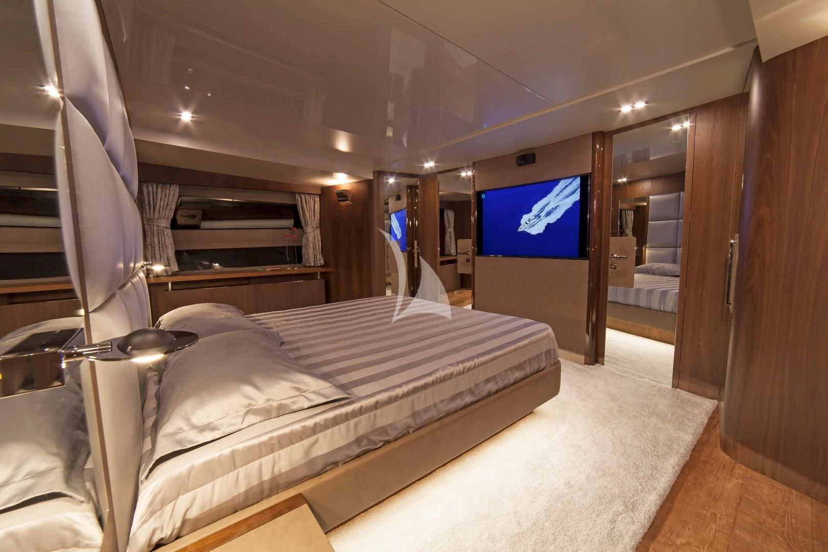 a room with a bed and a tv on the wall aboard SEATALY Yacht for Sale