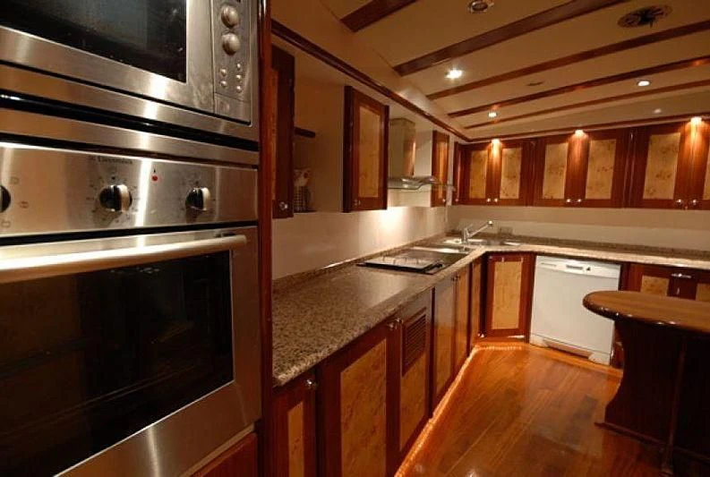 a kitchen with wooden cabinets aboard PHELAN GOOD Yacht for Sale