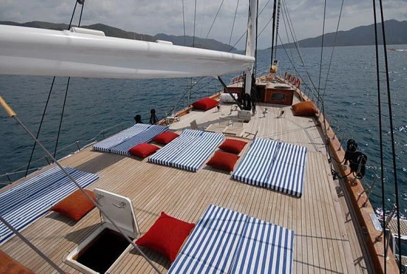 a deck with a boat and a deck with a red and white striped mat on it aboard PHELAN GOOD Yacht for Sale