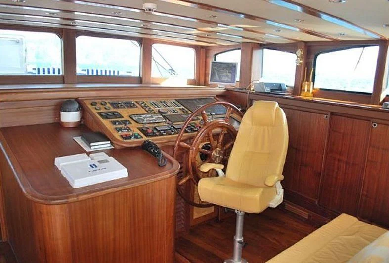 a wooden desk with a chair and a computer on it aboard PHELAN GOOD Yacht for Sale