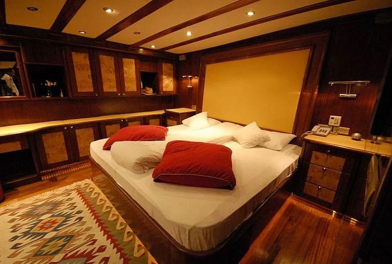a room with a bed and a desk aboard PHELAN GOOD Yacht for Sale