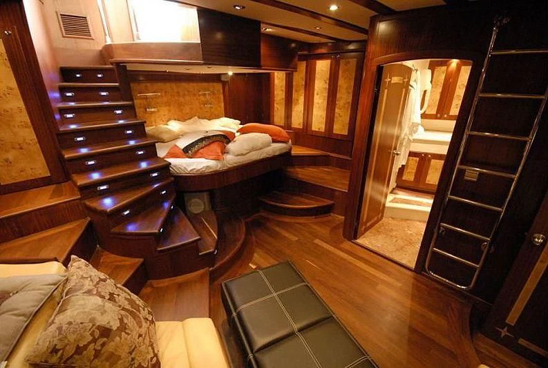 a room with a bed and a staircase aboard PHELAN GOOD Yacht for Sale