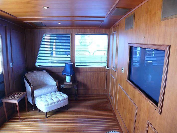 a room with a television and a chair aboard C SIDE Yacht for Sale