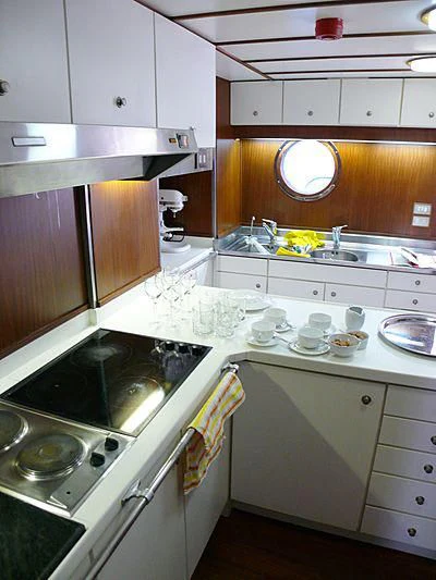 a kitchen with white cabinets aboard C SIDE Yacht for Sale
