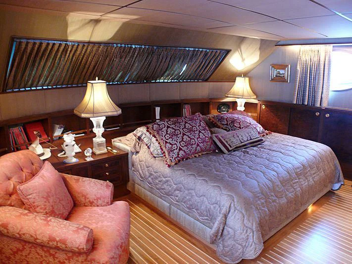 a bedroom with a large bed aboard C SIDE Yacht for Sale