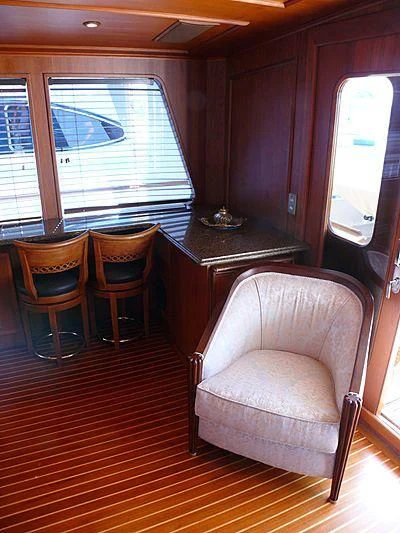 a chair and a table in a train aboard C SIDE Yacht for Sale