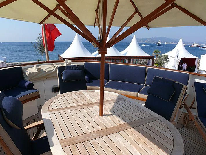 a table with chairs and umbrellas aboard C SIDE Yacht for Sale