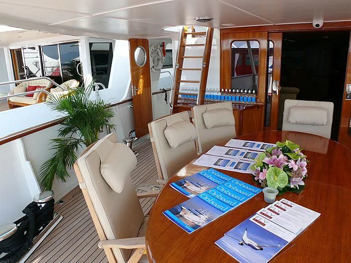 a living room with a table and chairs aboard C SIDE Yacht for Sale