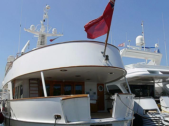a boat with a flag on the front aboard C SIDE Yacht for Sale