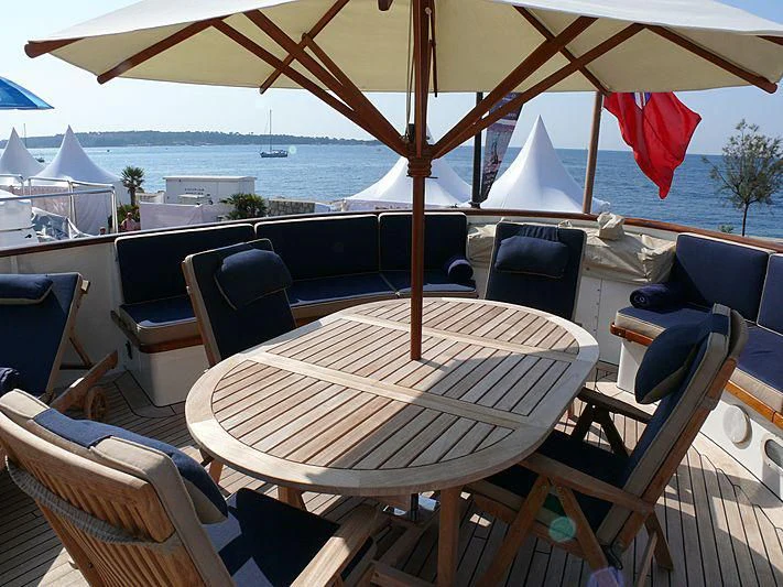 a table and chairs on a patio aboard C SIDE Yacht for Sale
