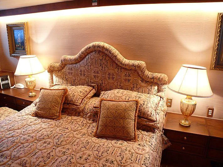 a large couch with a lamp on it next to a bed aboard C SIDE Yacht for Sale