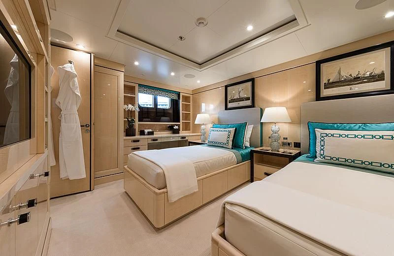 a room with a bed and a lamp aboard AMIGOS Yacht for Charter