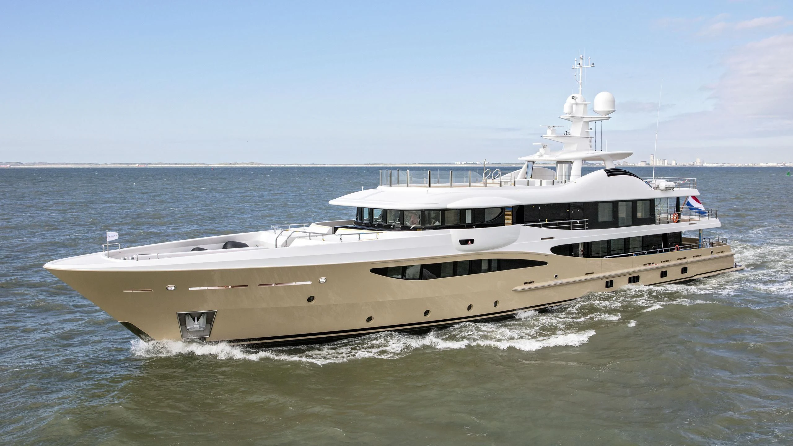a large white boat in the water aboard AMIGOS Yacht for Charter
