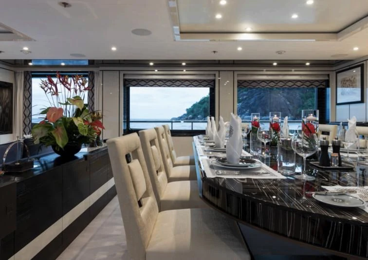 a dining room with a table set aboard AMIGOS Yacht for Charter