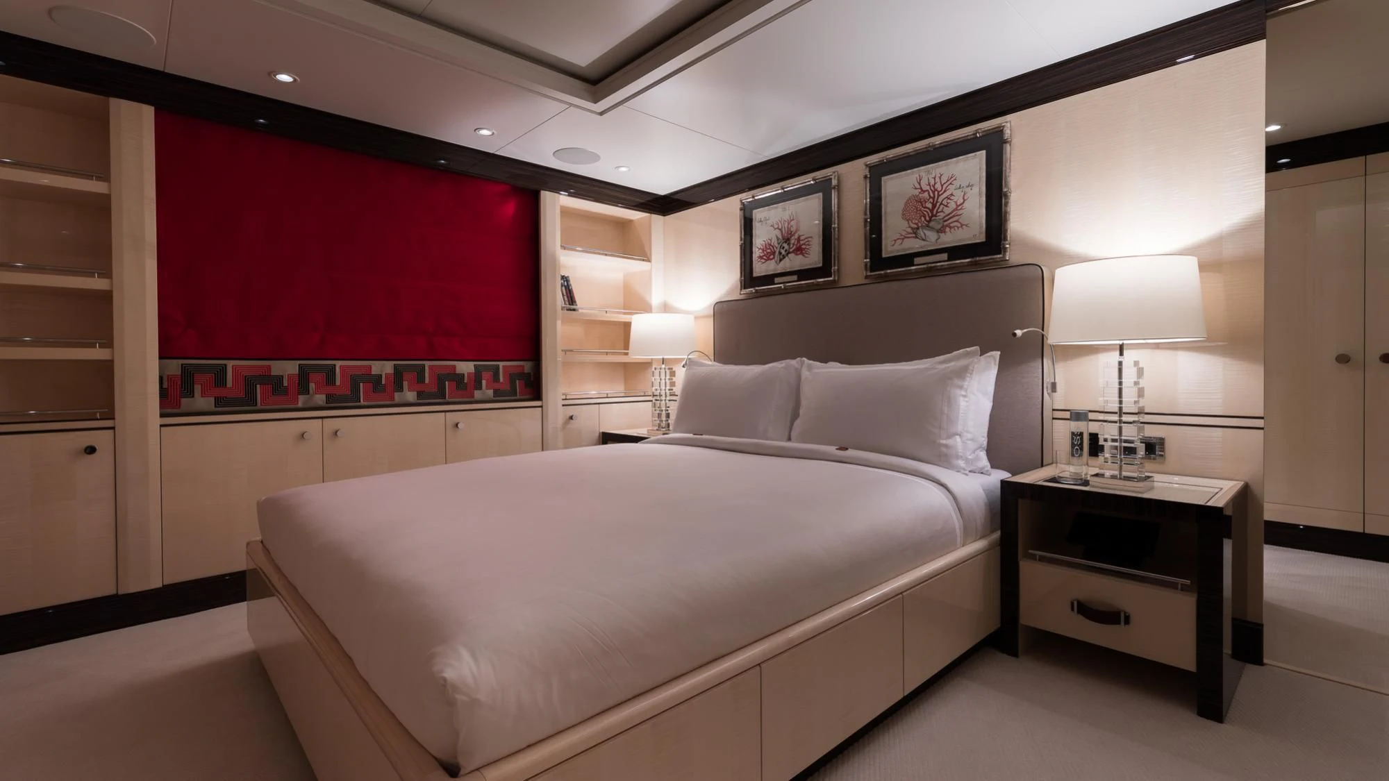 a room with a bed and a red wall aboard AMIGOS Yacht for Charter