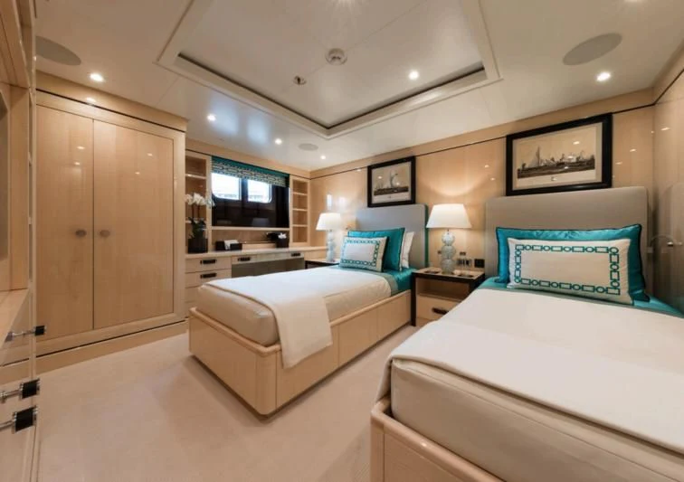 a couple of beds in a hotel room aboard AMIGOS Yacht for Charter