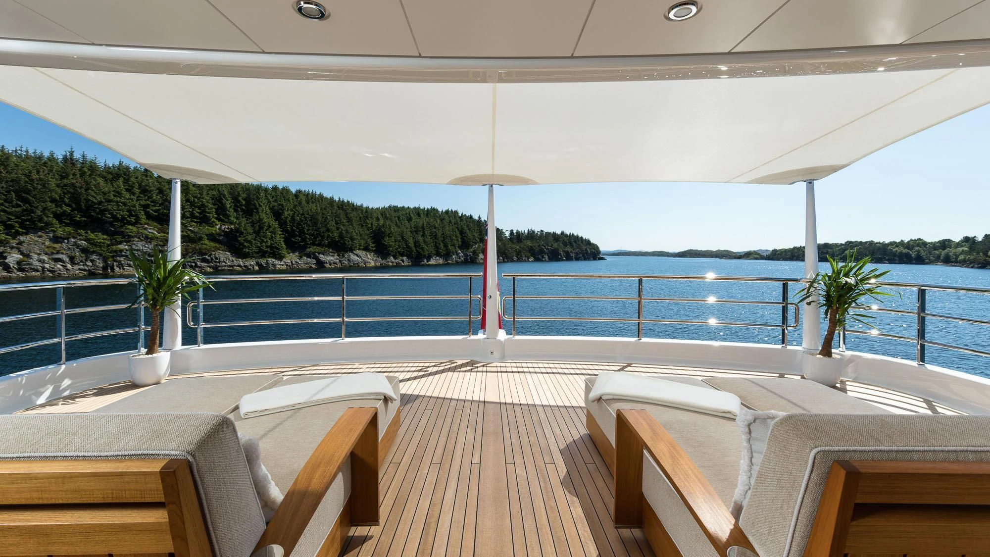 a deck with chairs and tables aboard AMIGOS Yacht for Charter