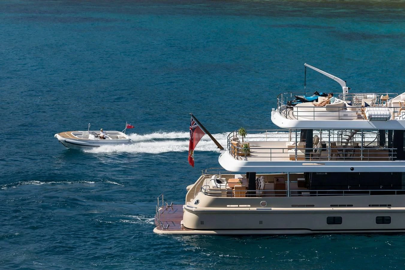 a boat with a flag on it aboard AMIGOS Yacht for Charter