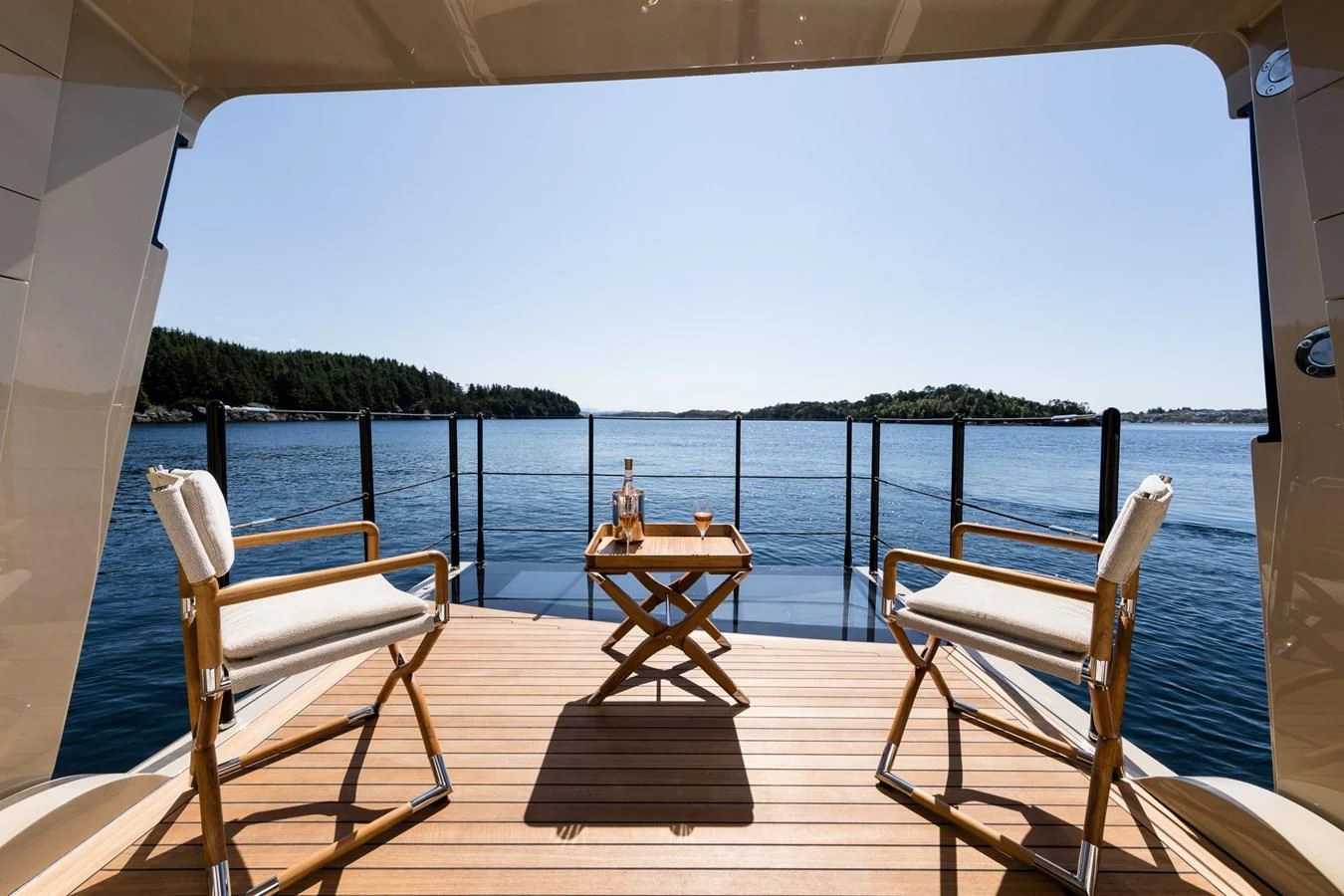 a deck with chairs and a table on it aboard AMIGOS Yacht for Charter