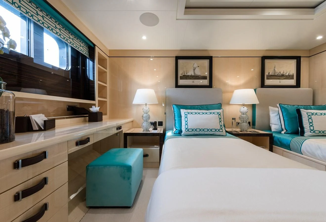 a room with a bed and a desk aboard AMIGOS Yacht for Charter
