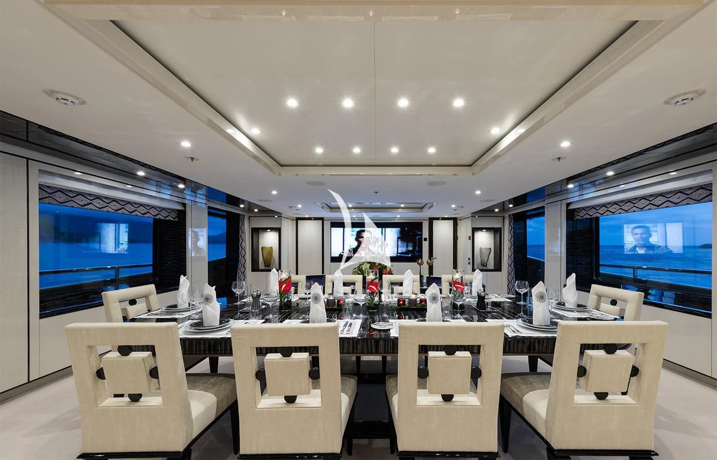 a large room with tables and chairs aboard AMIGOS Yacht for Charter