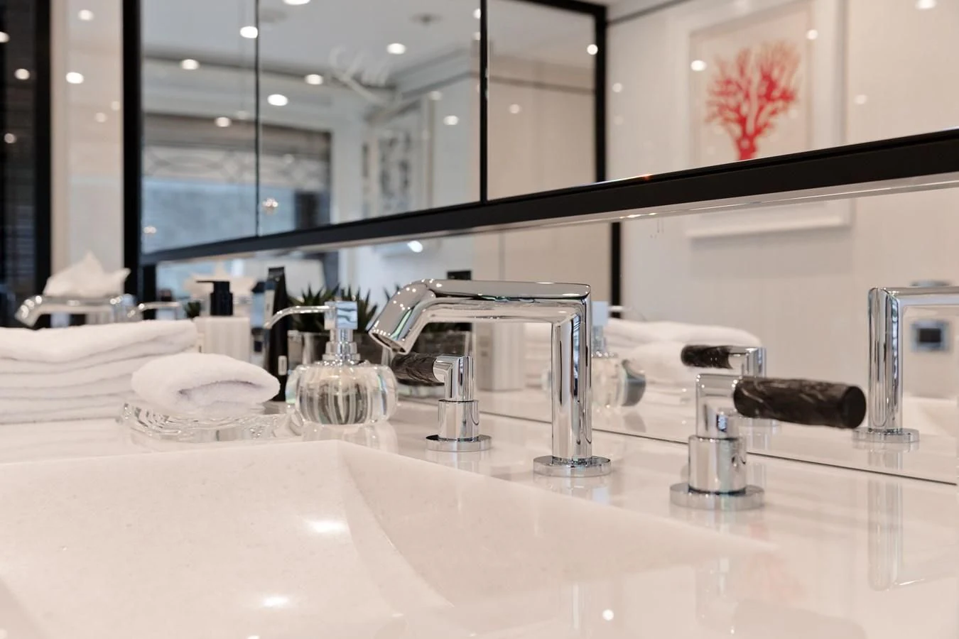 a bathroom sink with a mirror aboard AMIGOS Yacht for Charter