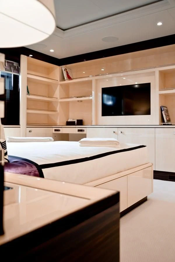 a room with a bed and a tv aboard AMIGOS Yacht for Charter