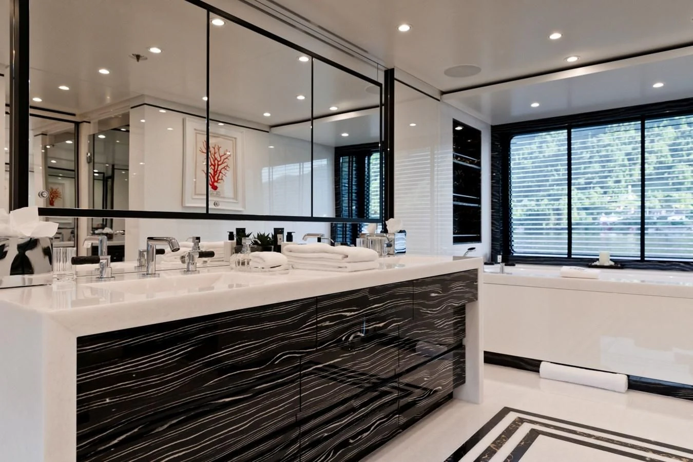 a large bathroom with a large mirror aboard AMIGOS Yacht for Charter