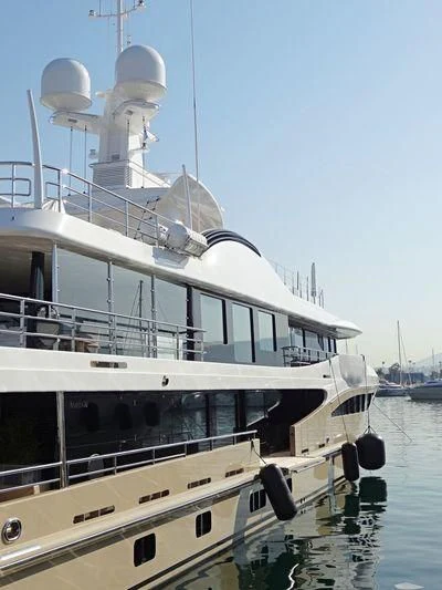 a large white boat with a white tower on it aboard AMIGOS Yacht for Charter