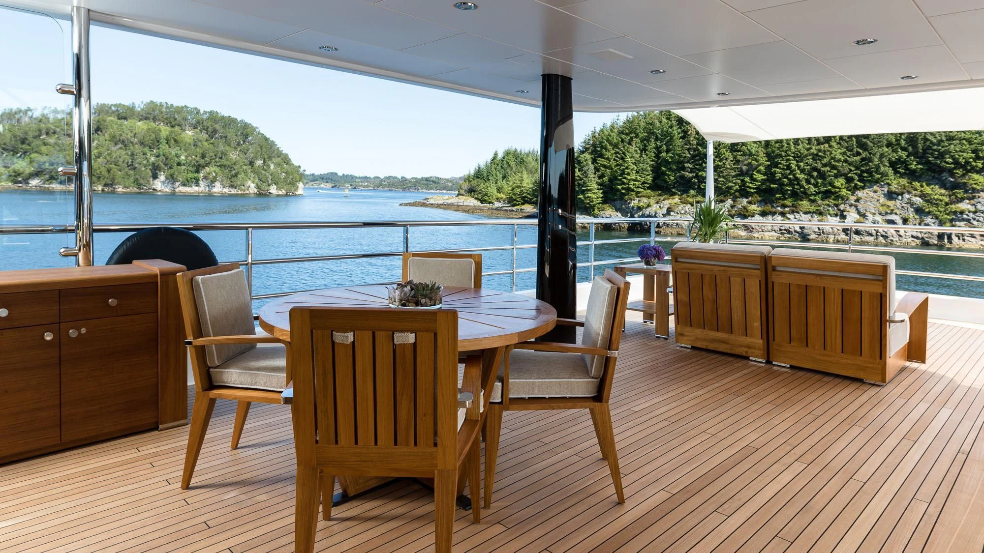 a table and chairs on a deck aboard AMIGOS Yacht for Charter