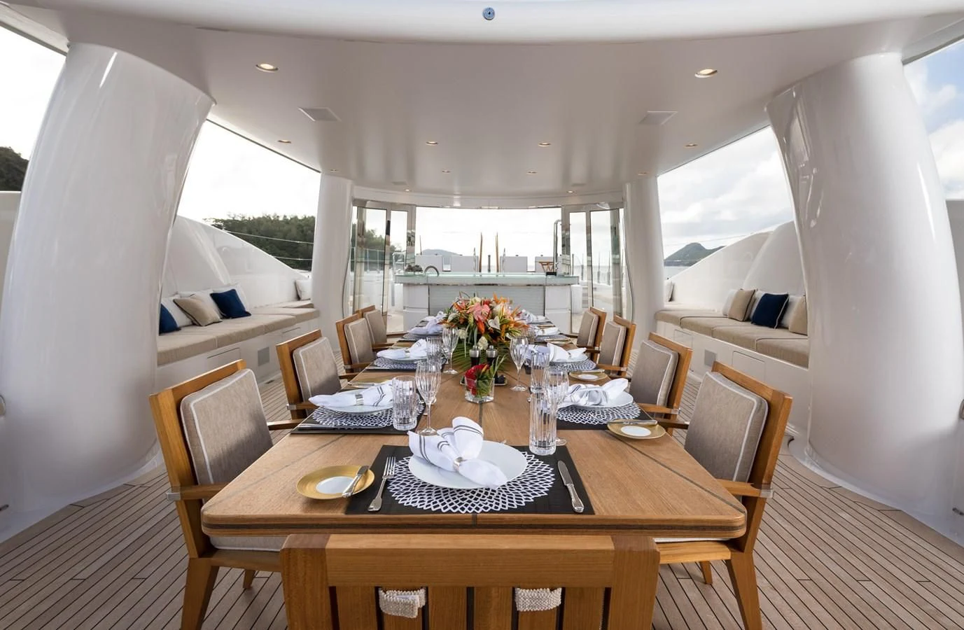a dining table with chairs and a large window aboard AMIGOS Yacht for Charter