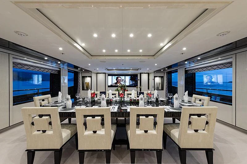 a large room with tables and chairs aboard AMIGOS Yacht for Charter