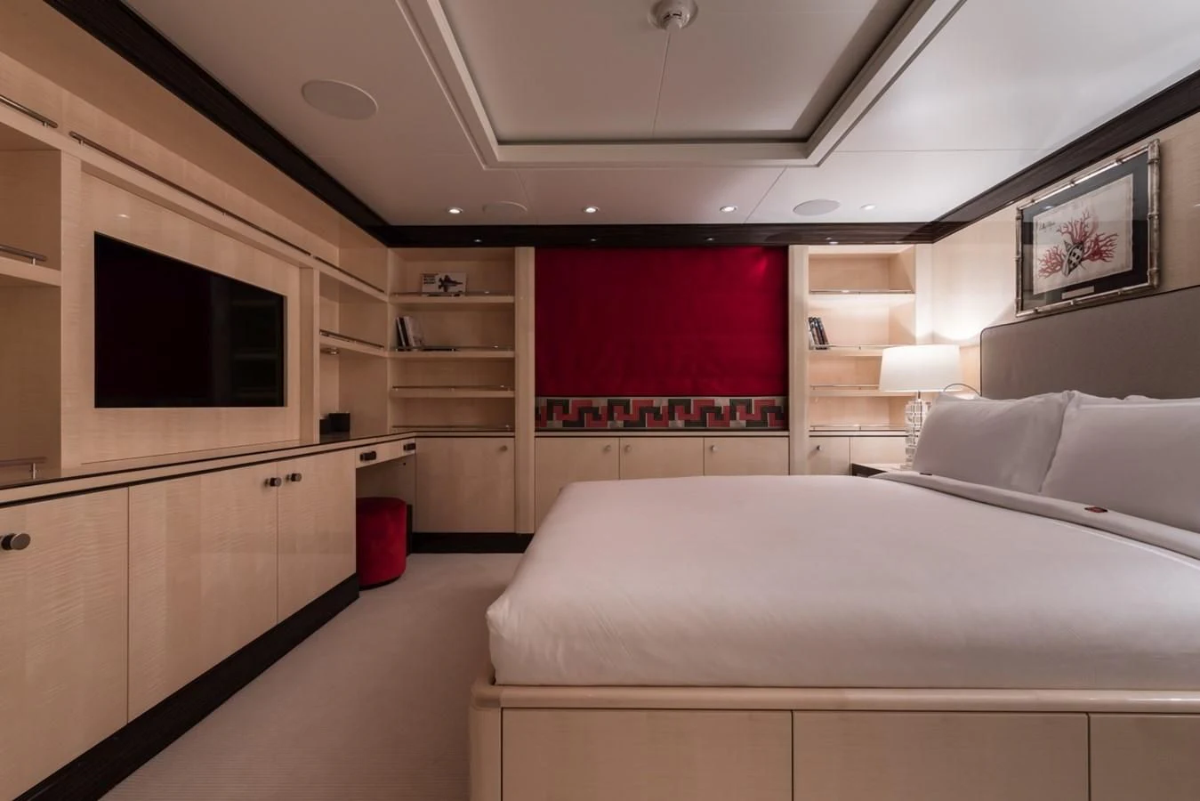 a room with a bed and a tv aboard AMIGOS Yacht for Charter