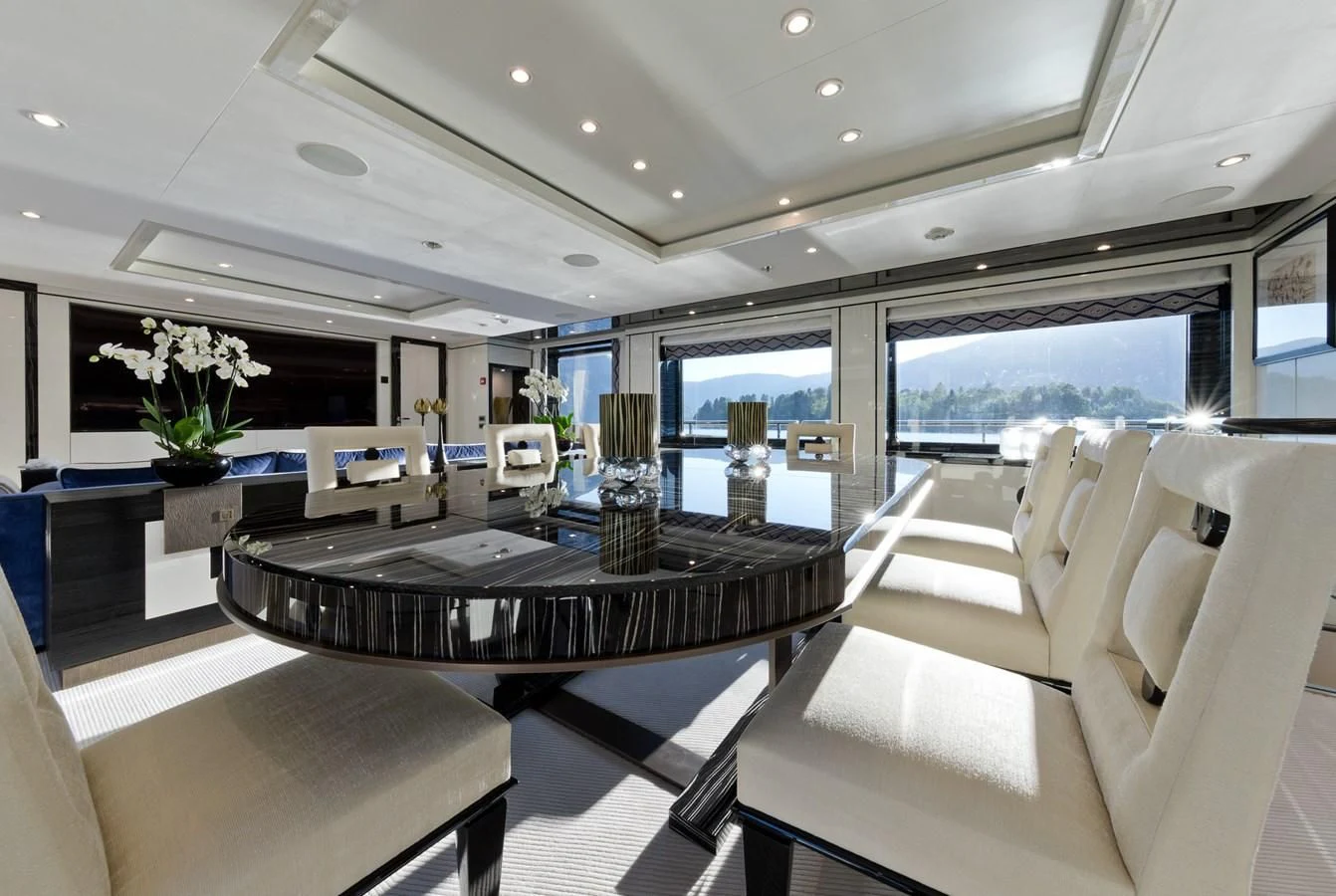 a large room with a table and chairs aboard AMIGOS Yacht for Charter