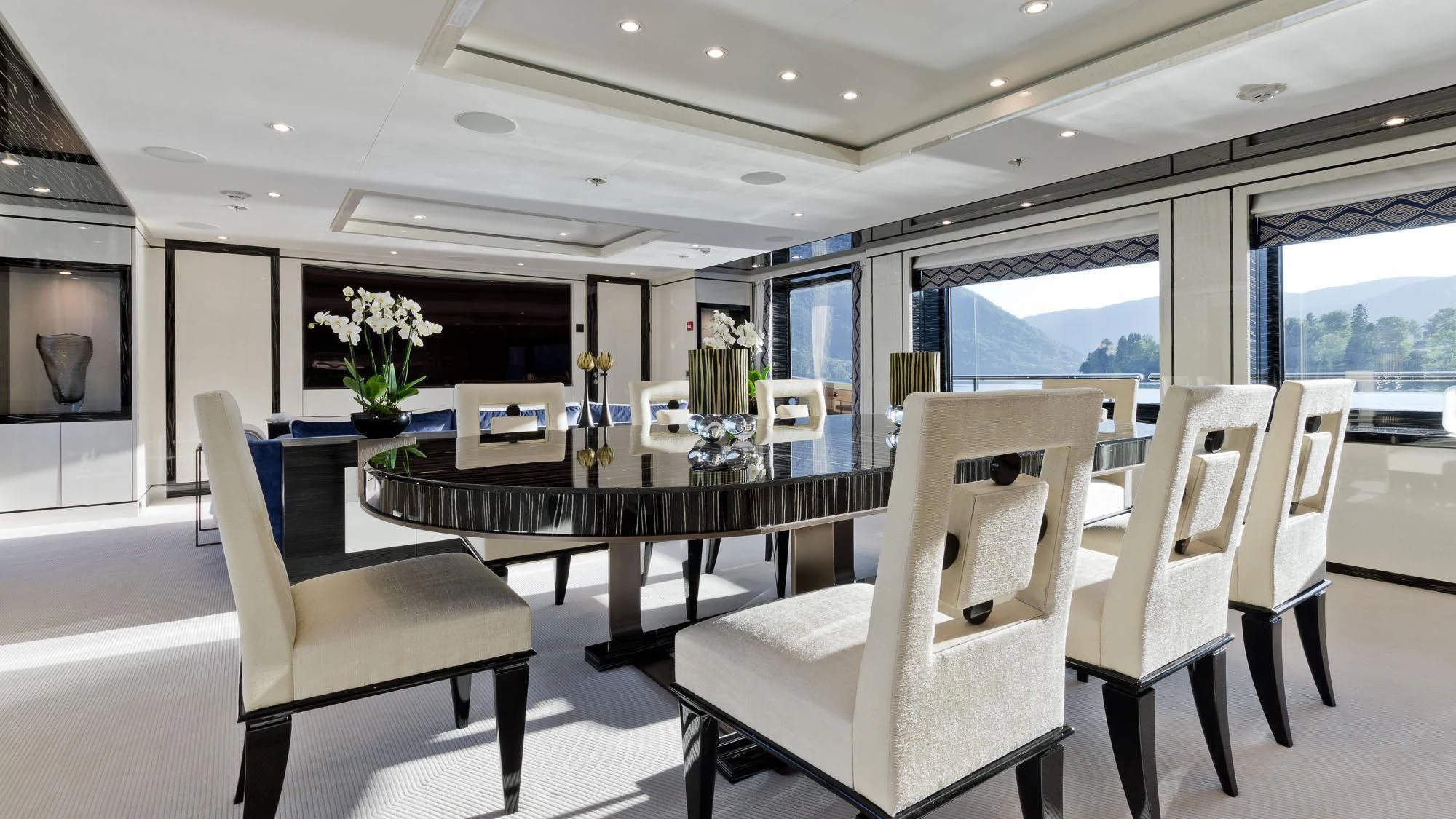 a room with a table chairs and a fireplace aboard AMIGOS Yacht for Charter