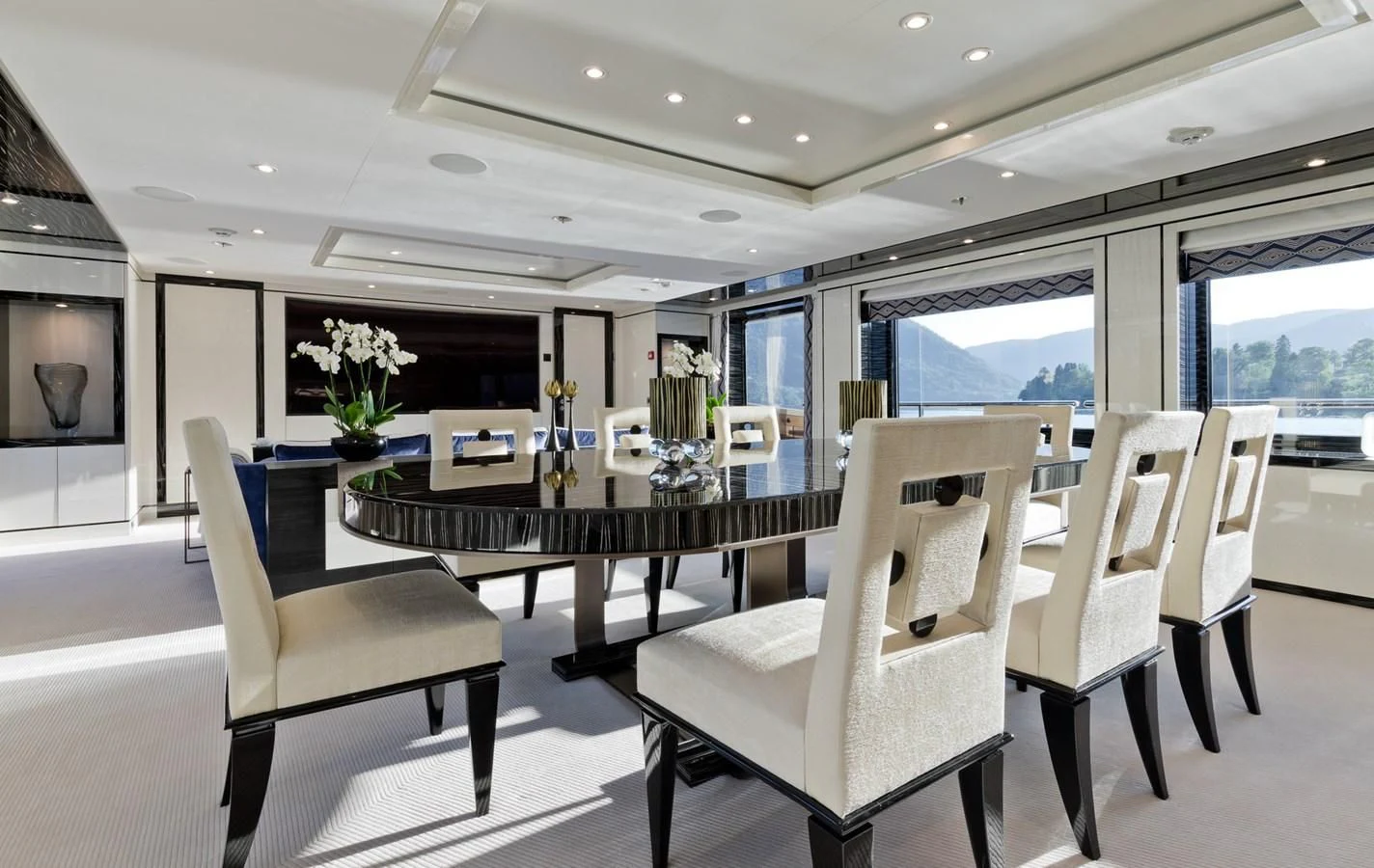 a room with a table chairs and a fireplace aboard AMIGOS Yacht for Charter