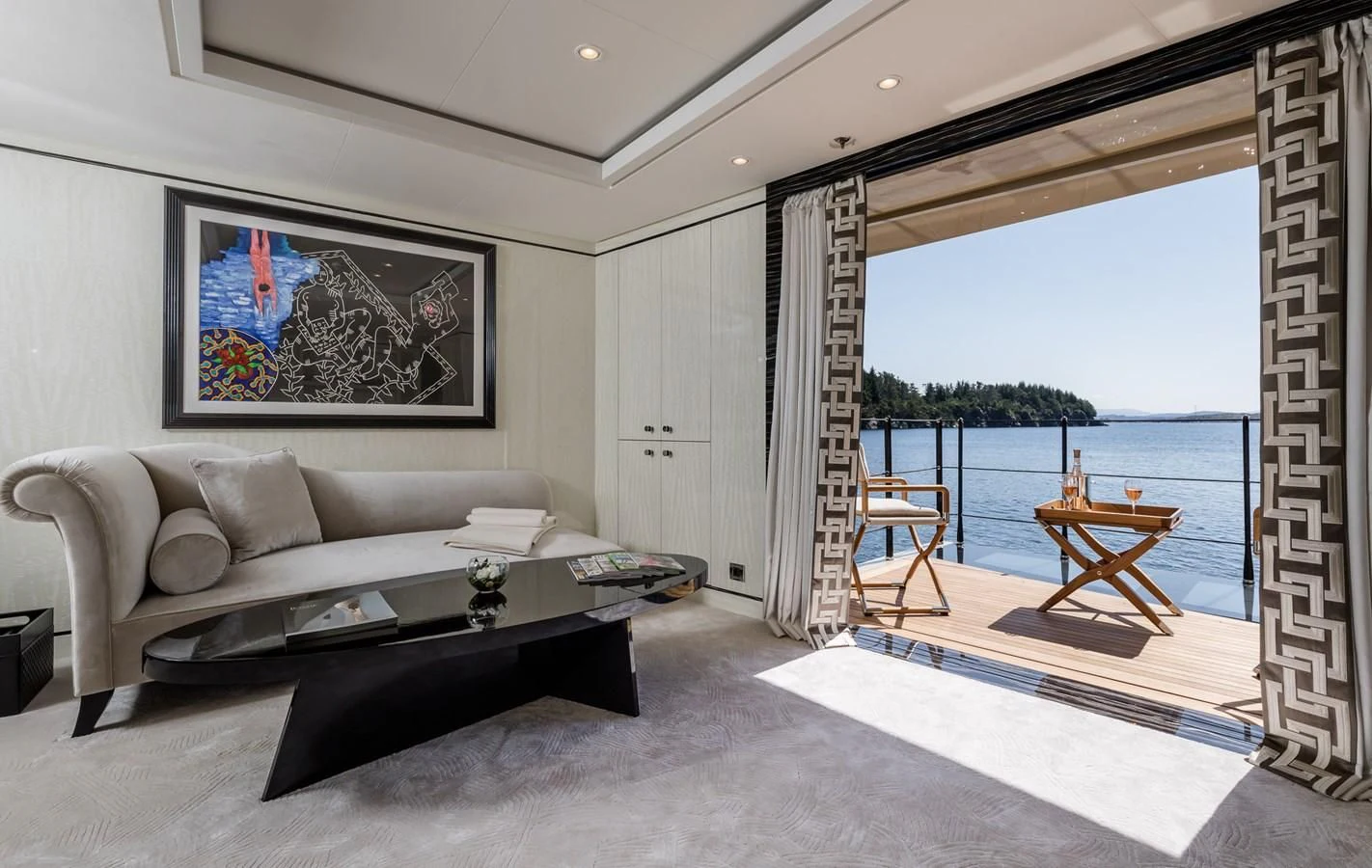 a living room with a large window aboard AMIGOS Yacht for Charter