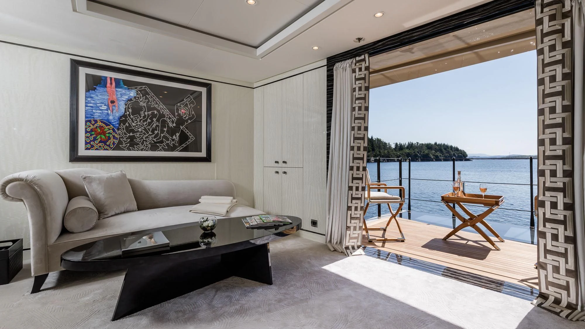 a living room with a large window aboard AMIGOS Yacht for Charter