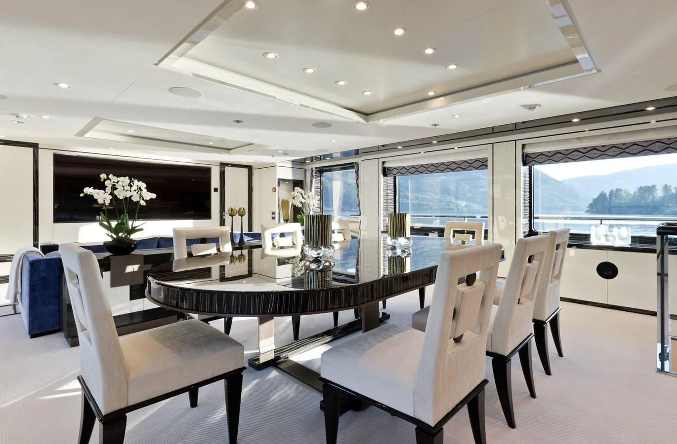 a large room with a table and chairs aboard AMIGOS Yacht for Charter