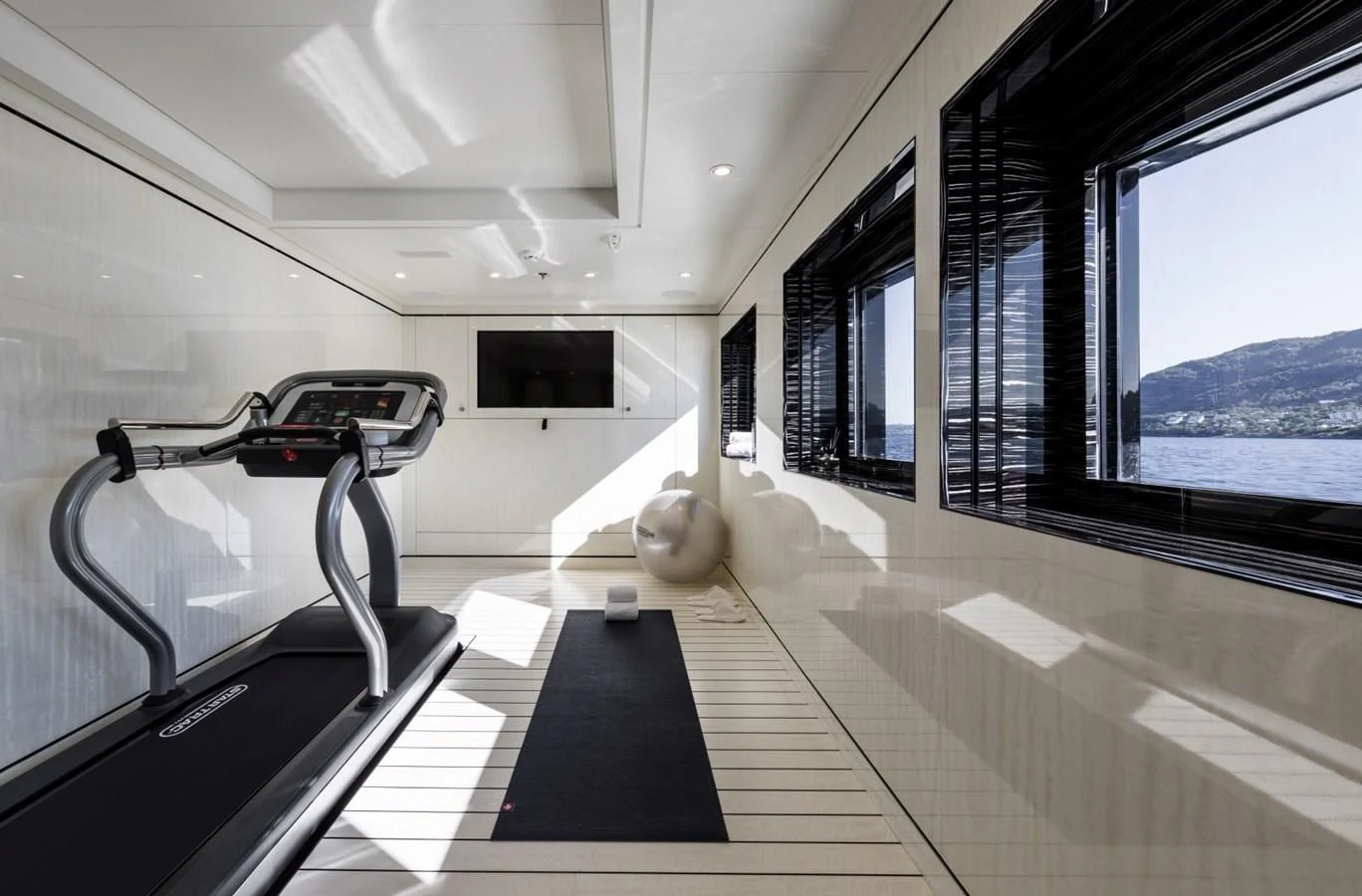 a room with a large window and a large bed with a large window aboard AMIGOS Yacht for Charter