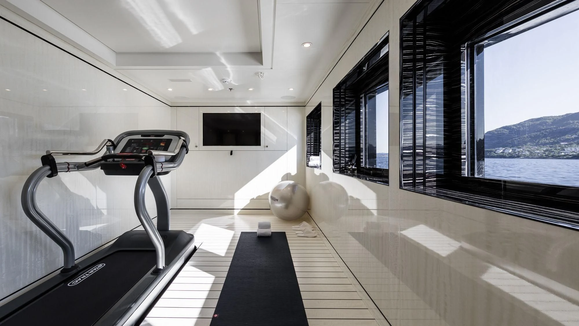 a room with a large window and a large bed in it aboard AMIGOS Yacht for Charter