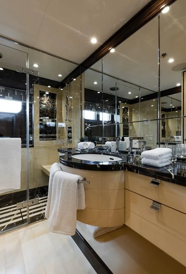 a bathroom with a glass shower aboard AMIGOS Yacht for Charter