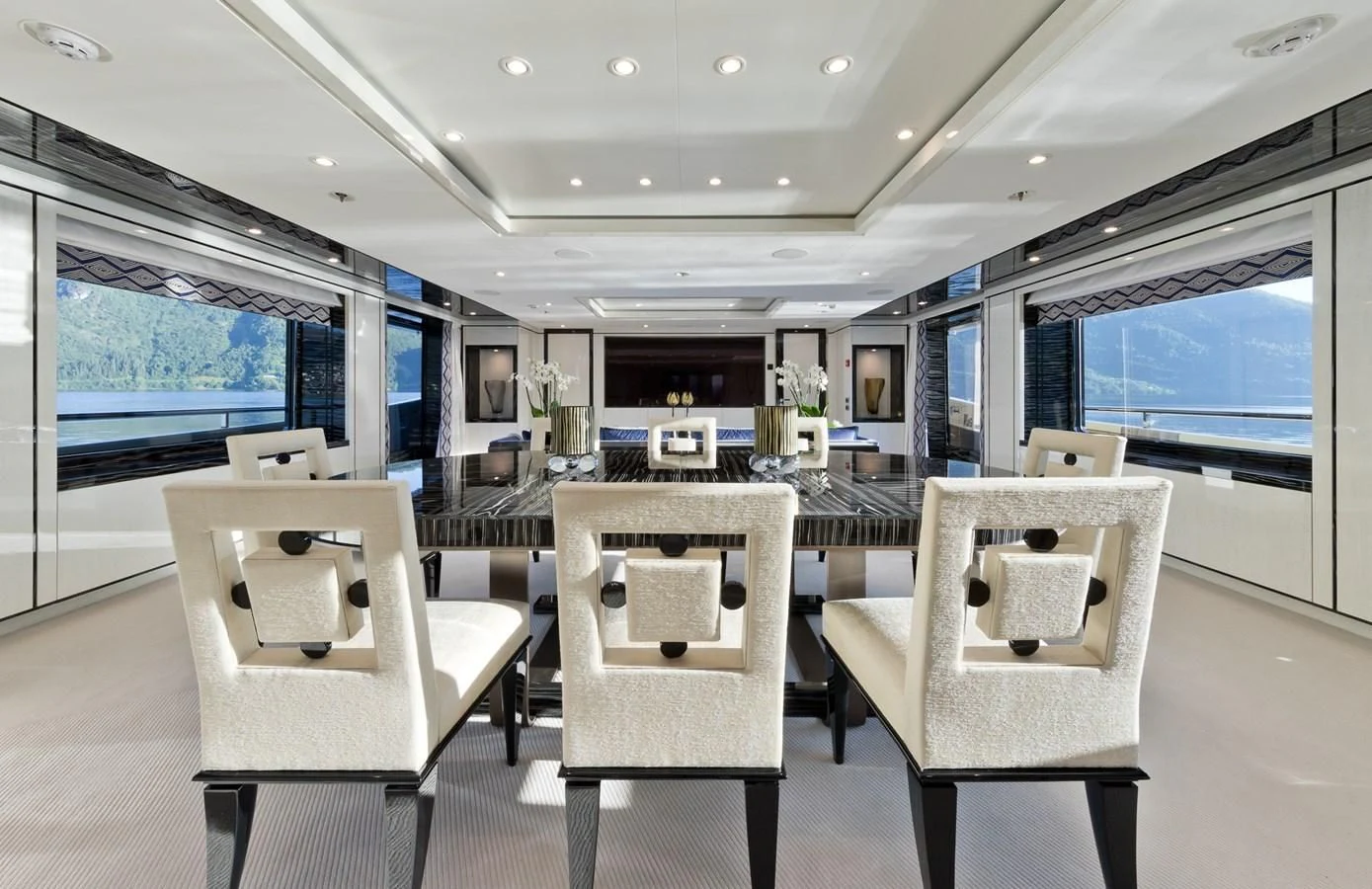 a room with chairs and tables aboard AMIGOS Yacht for Charter