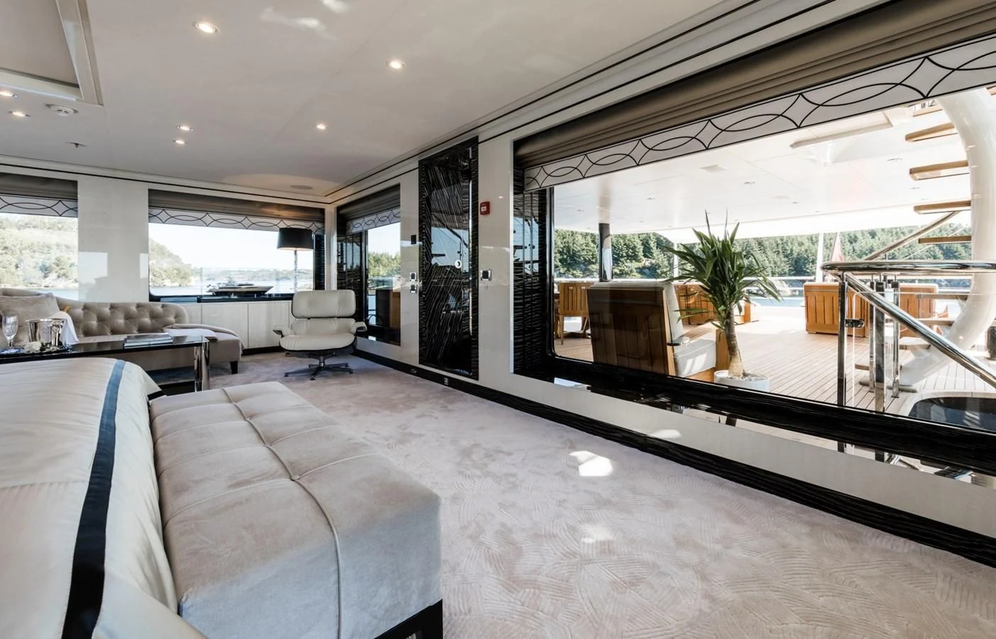 a large room with a large glass window and a couch aboard AMIGOS Yacht for Charter