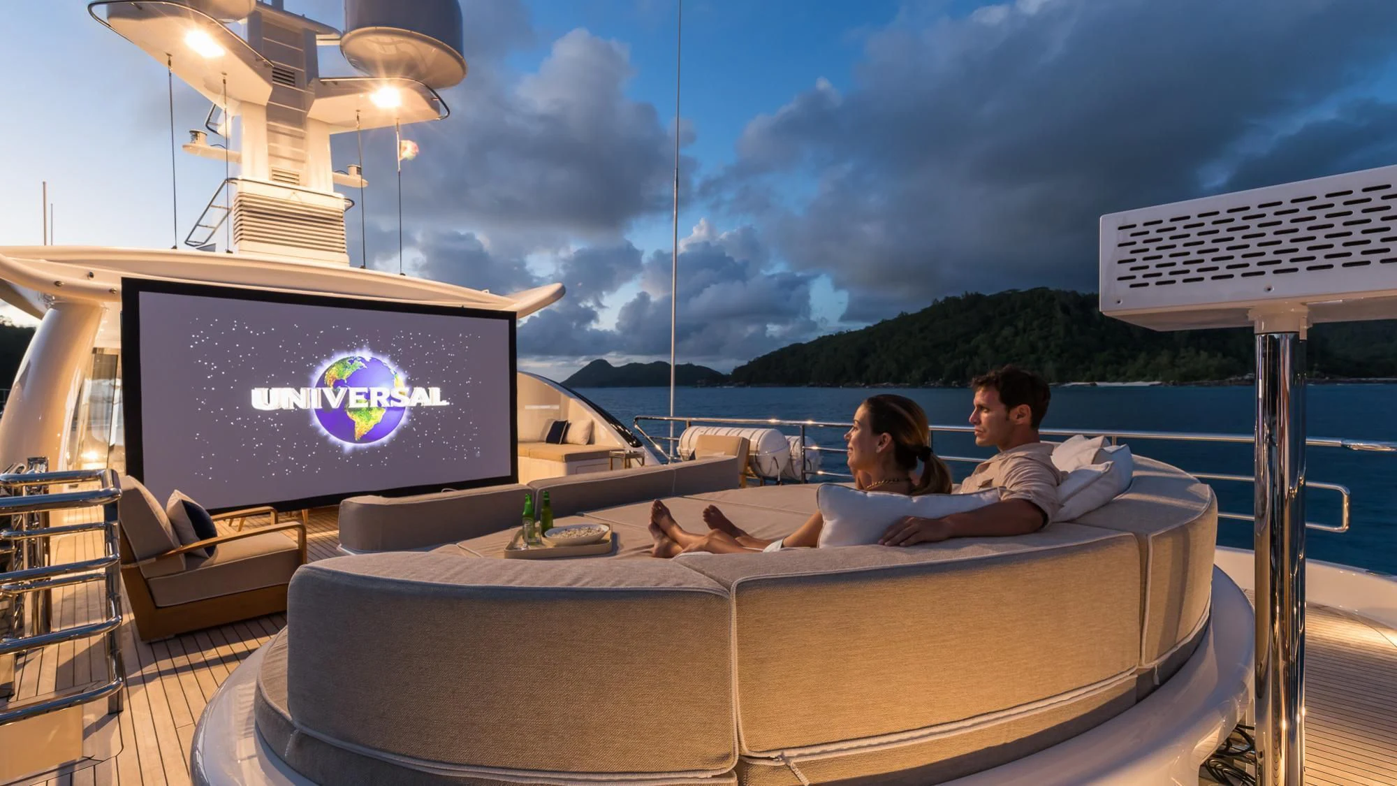 a group of people sitting on a couch in front of a television aboard AMIGOS Yacht for Charter