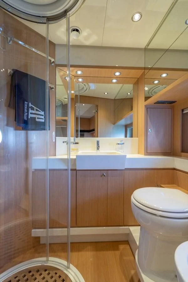 a bathroom with a glass shower aboard NAMEDROPPER Yacht for Sale
