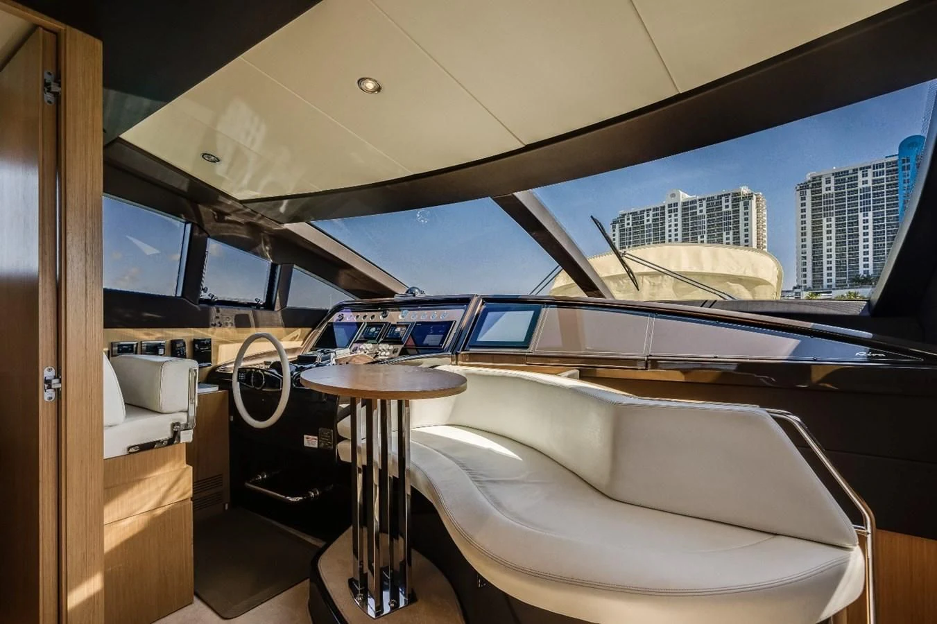a room with a table and a window with a view of the city aboard NAMEDROPPER Yacht for Sale
